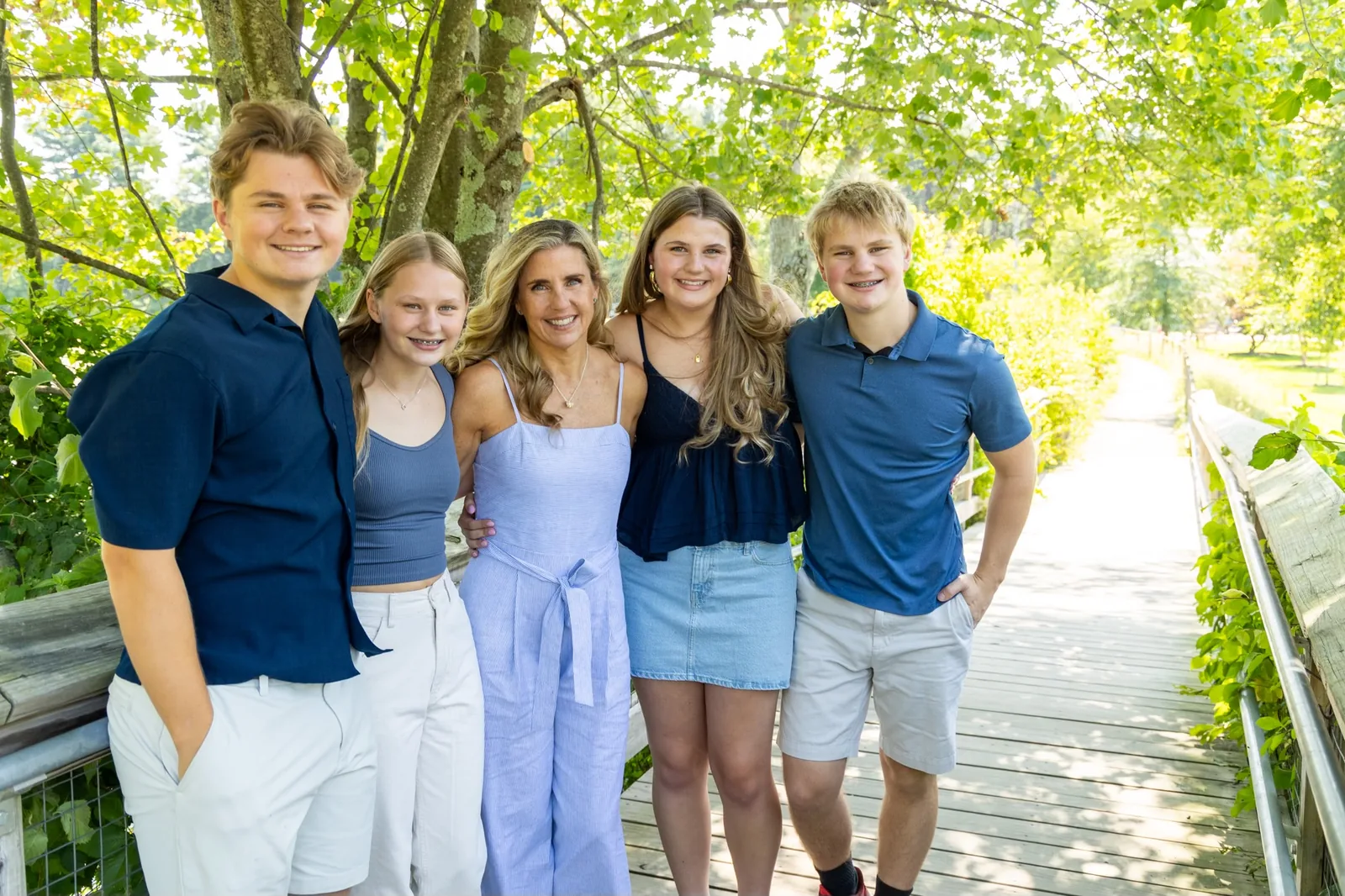 A mother with her four teenagers on a boardwalk
